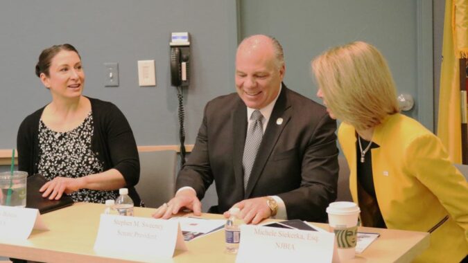 NJBIA Chief Government Affairs Officer Chrissy Buteas (left), Senate President Stephen Sweeney, NJBIA President and CEO Michele Siekerka at a table a