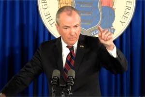 Gov. Phil Murphy at a press conference in front of the Seal of New Jersey.