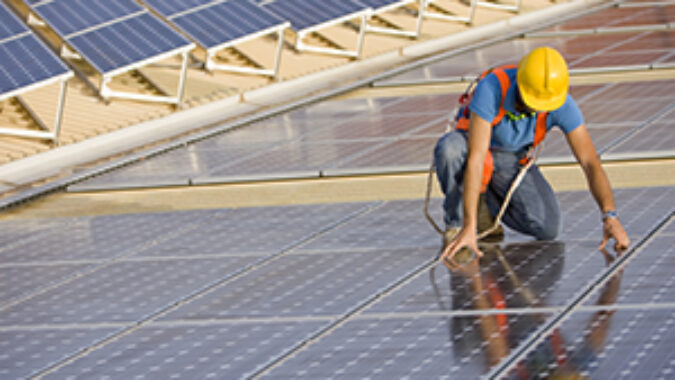 image of worker installing photovoltaic solar panel