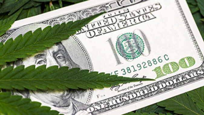 Leaf of marijuana in cash hundred dollar bills. A sheet of marijuana for money, dollars and cannabis