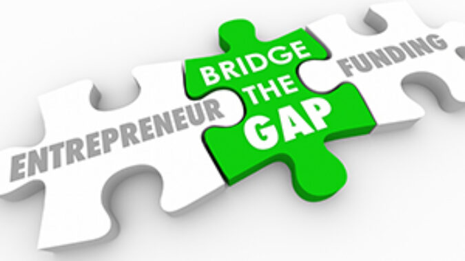 Three jigsaw puzzle pieces with one in the middle labeled "bridge the gap" connecting "entrepreneur" and "funding"