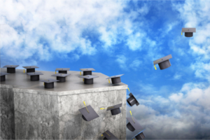 graduation caps flying from a slab of stone into the air.