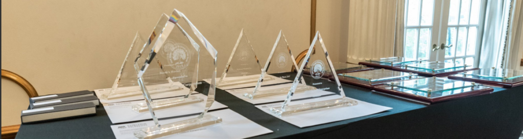 Glass award trophies sitting on an awards table