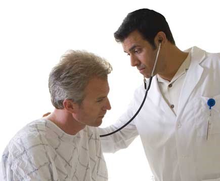 Male doctor with stethoscope examining male patient. 