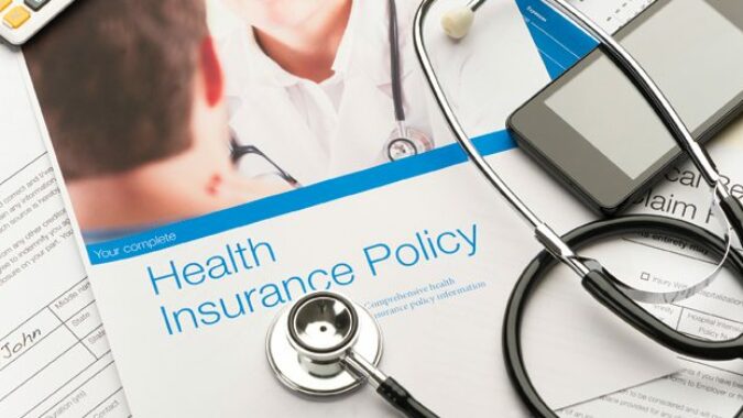 Healthcare policy booklet and stethoscope