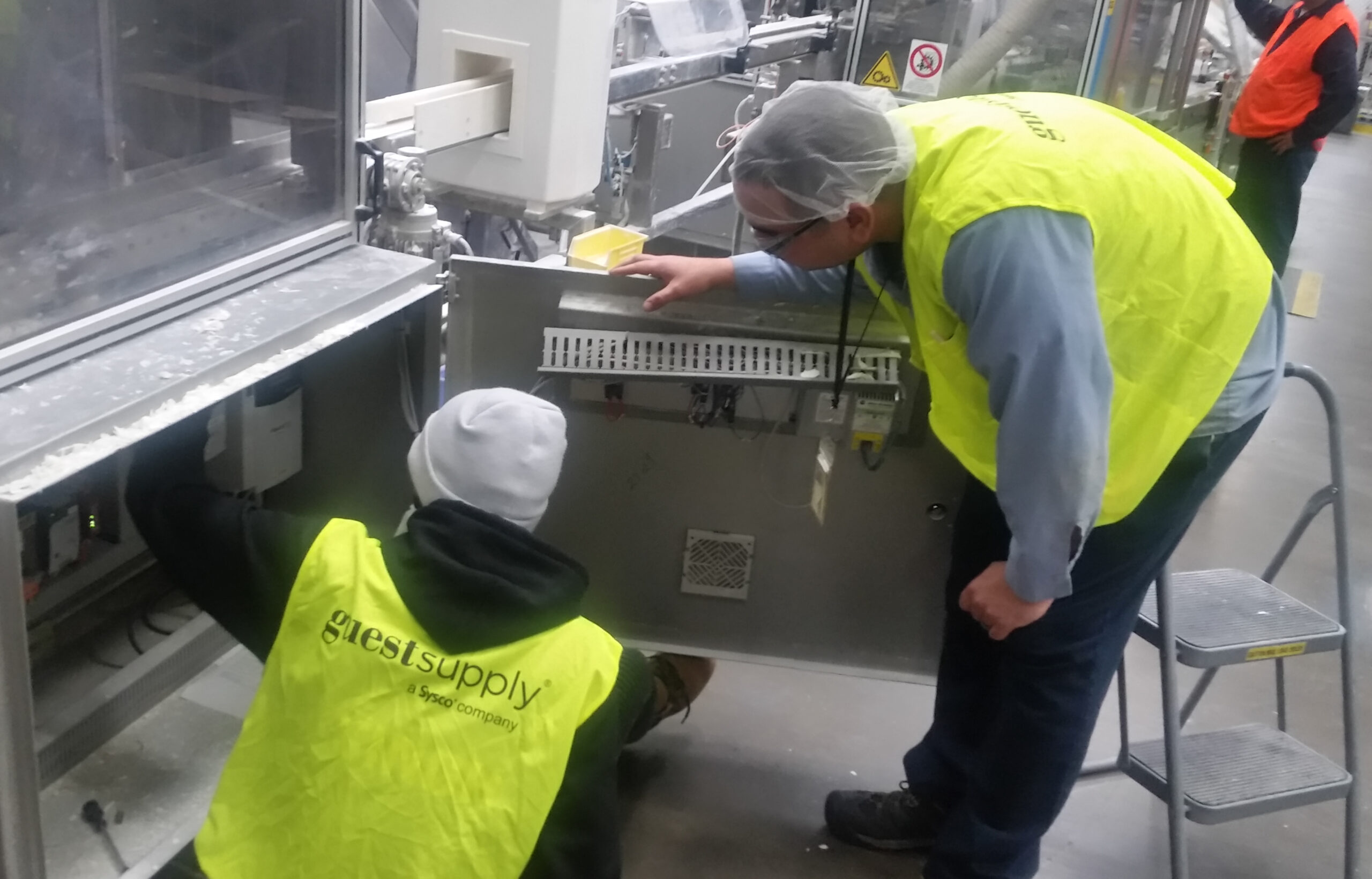 A student working at Gilchrist and Soames while receiving instruction from Plant Manager David Baron. 
