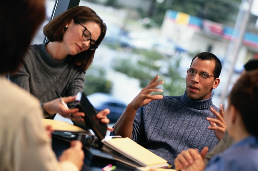 Young business leaders discuss e-commerce around a table 