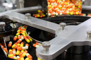 pharmacy medicine capsule pill in production line at medical factory. selective focus.