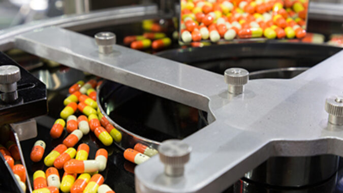 pharmacy medicine capsule pill in production line at medical factory. selective focus.