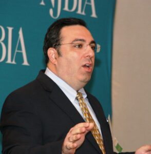 Attorney Michael Shadiack of Connell Foley speaking in front of an NJBIA step and repeat.