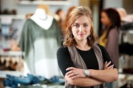 Confident business woman, arms folded, looking at the camera.